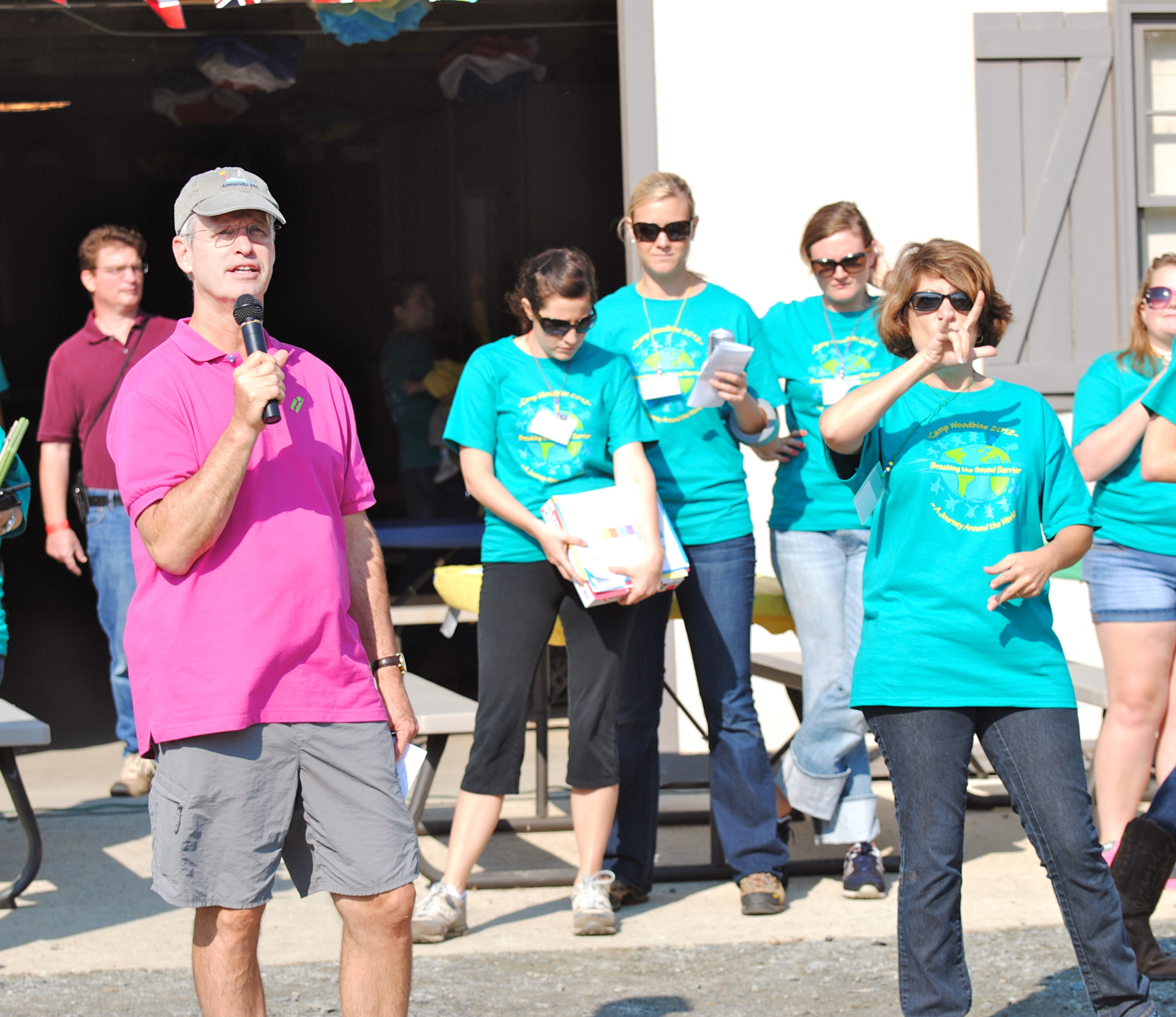 Dr. John T. McElveen Jr. speaking to campers alongside Camp Woodbine volunteers