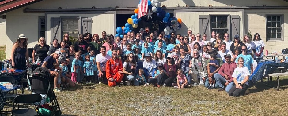 Camp Woodbine families and volunteers gathered for a group photo