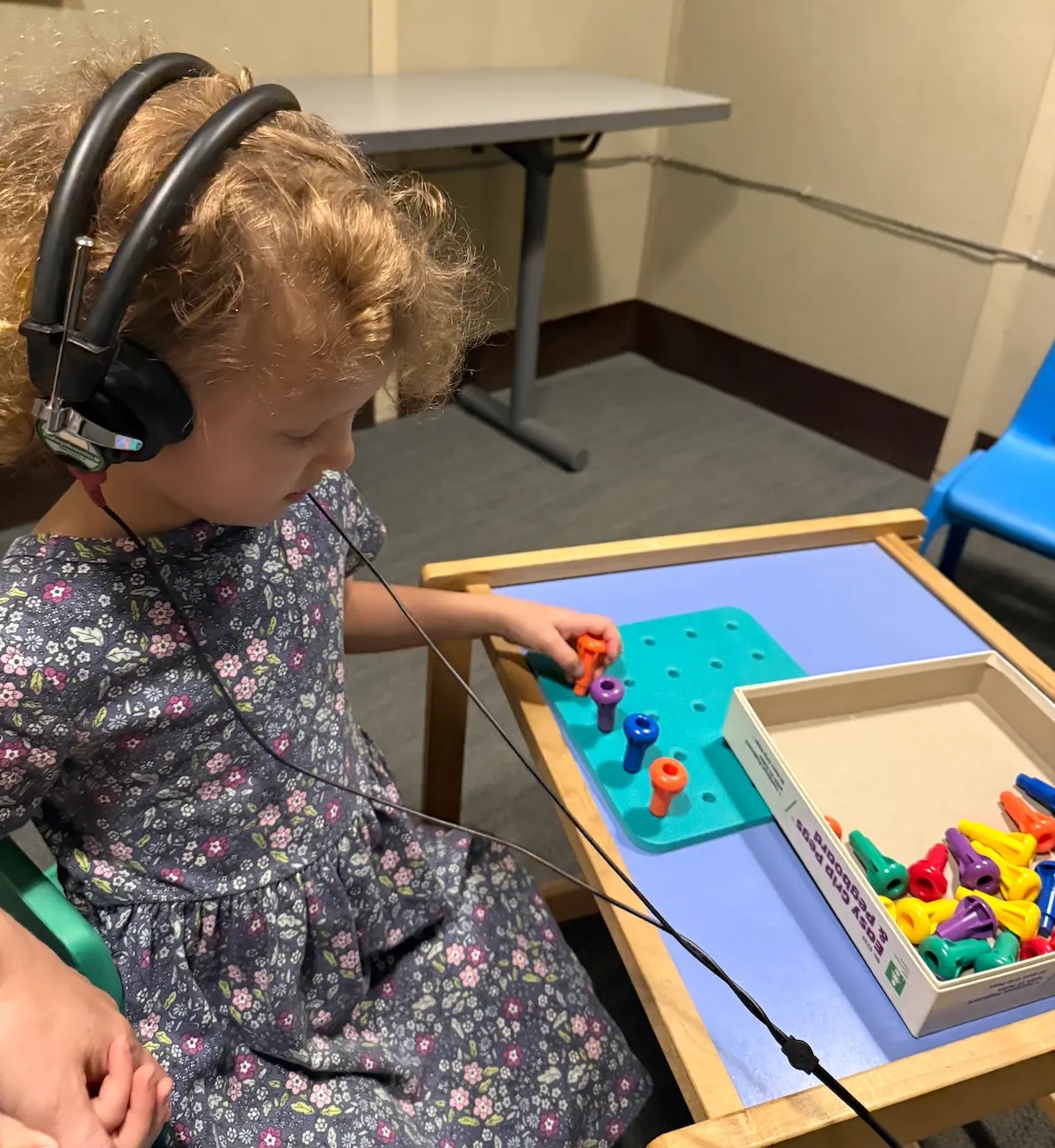 Young patient wearing headphones during a play-based hearing test